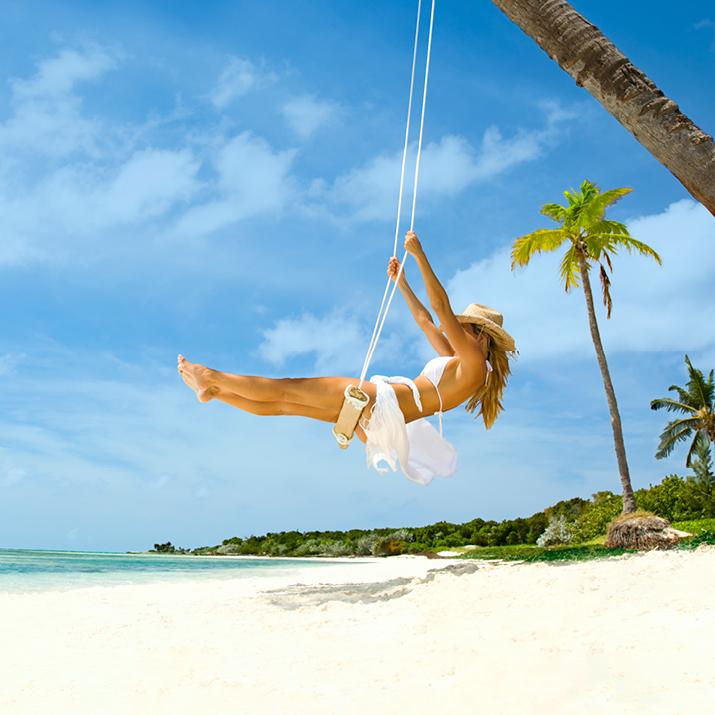 woman on swing on the beach